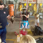 firefighter speaking to children in fire hall