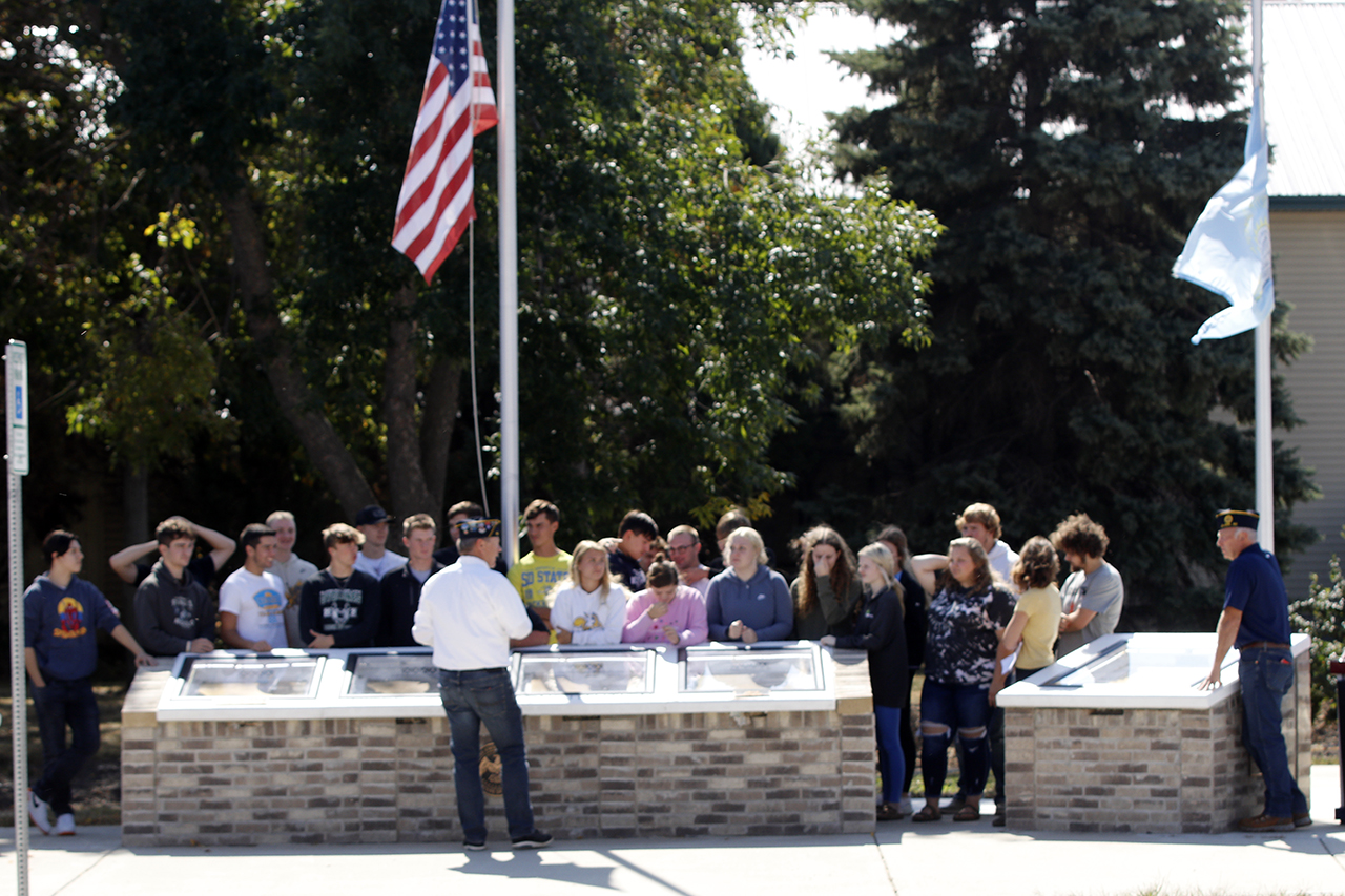 class gathers at war memorial