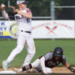 young teenage baseball player throwing a ball after getting the player at his feet out