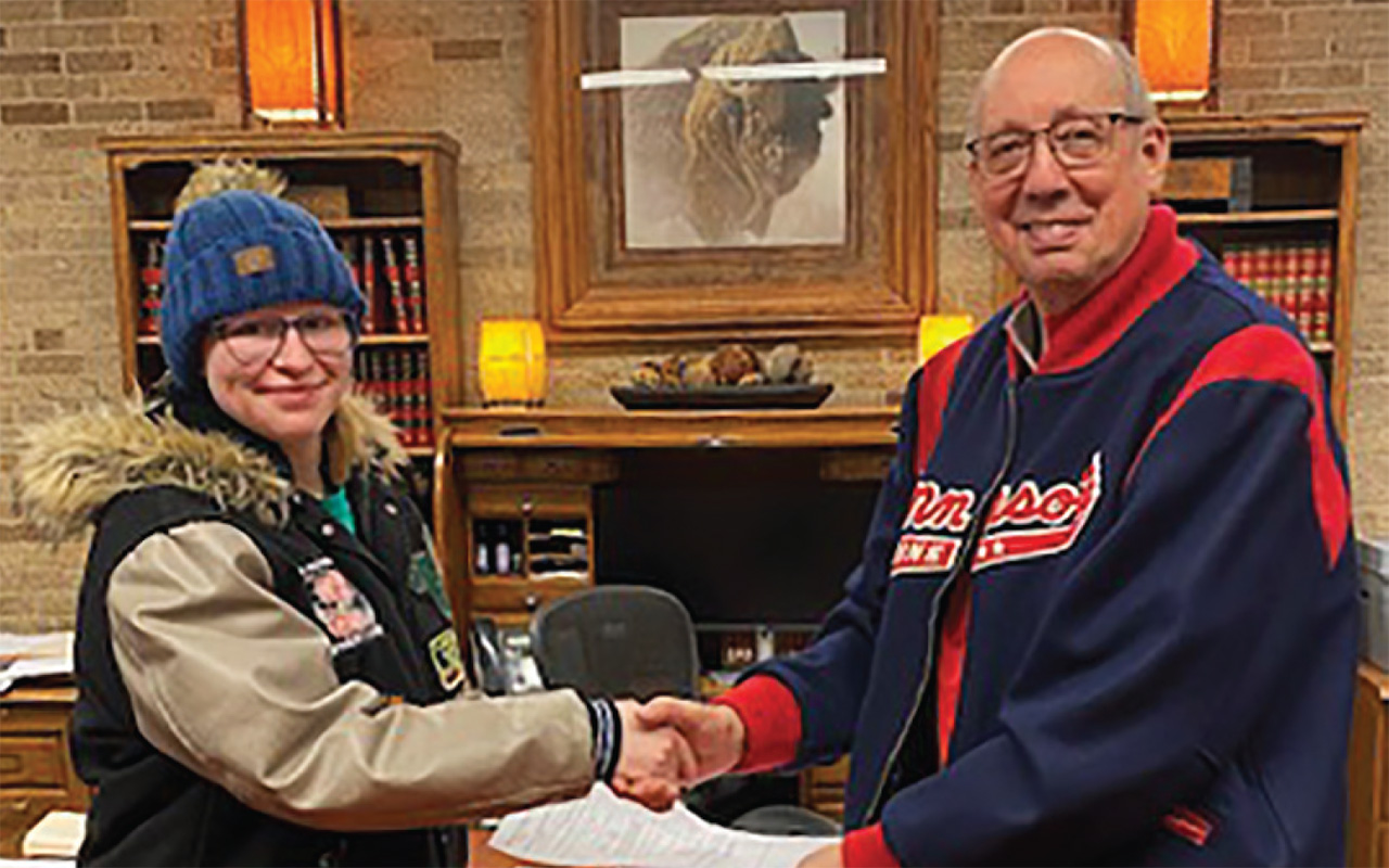 Karli Paulson and Bill Krikac shake hands
