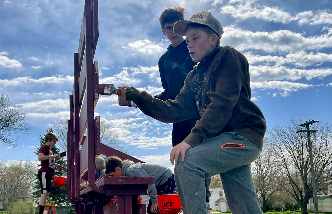 boys painting bleachers